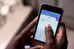 Josiane shows how she uses Mobile Money on her phone in Ivory Coast