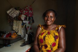 Cristelle smiles in her shop in Ivory Coast, as she explains how Mobile Money has helped her business grow