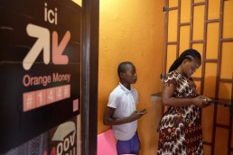 Nadege withdraws money from a kiosk using her Mobile Money account in Ivory Coast