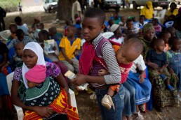Children wait to be vaccinated against measles and rubella with GAVI in Tanzania